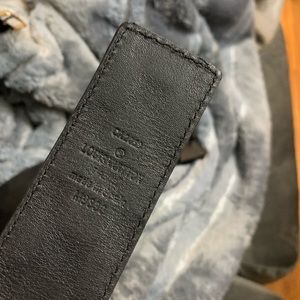 Louis Vuitton belt with a matte black LV initials buckle.